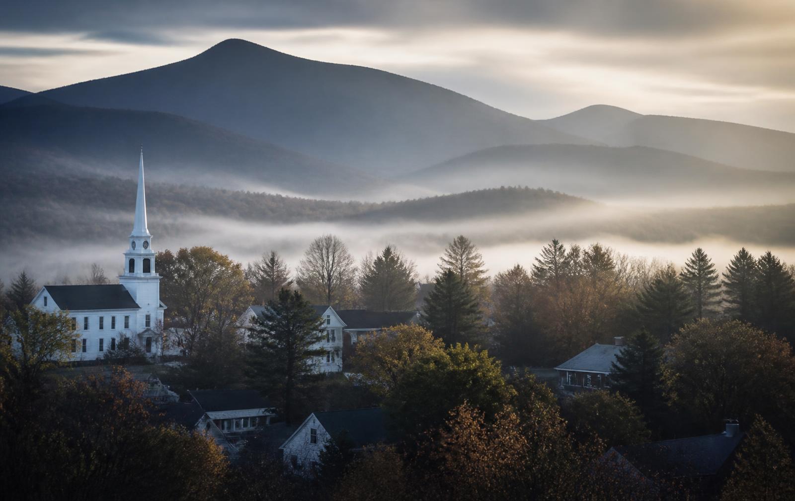 A small northern New Hampshire village at dawn beneath the White Mountains